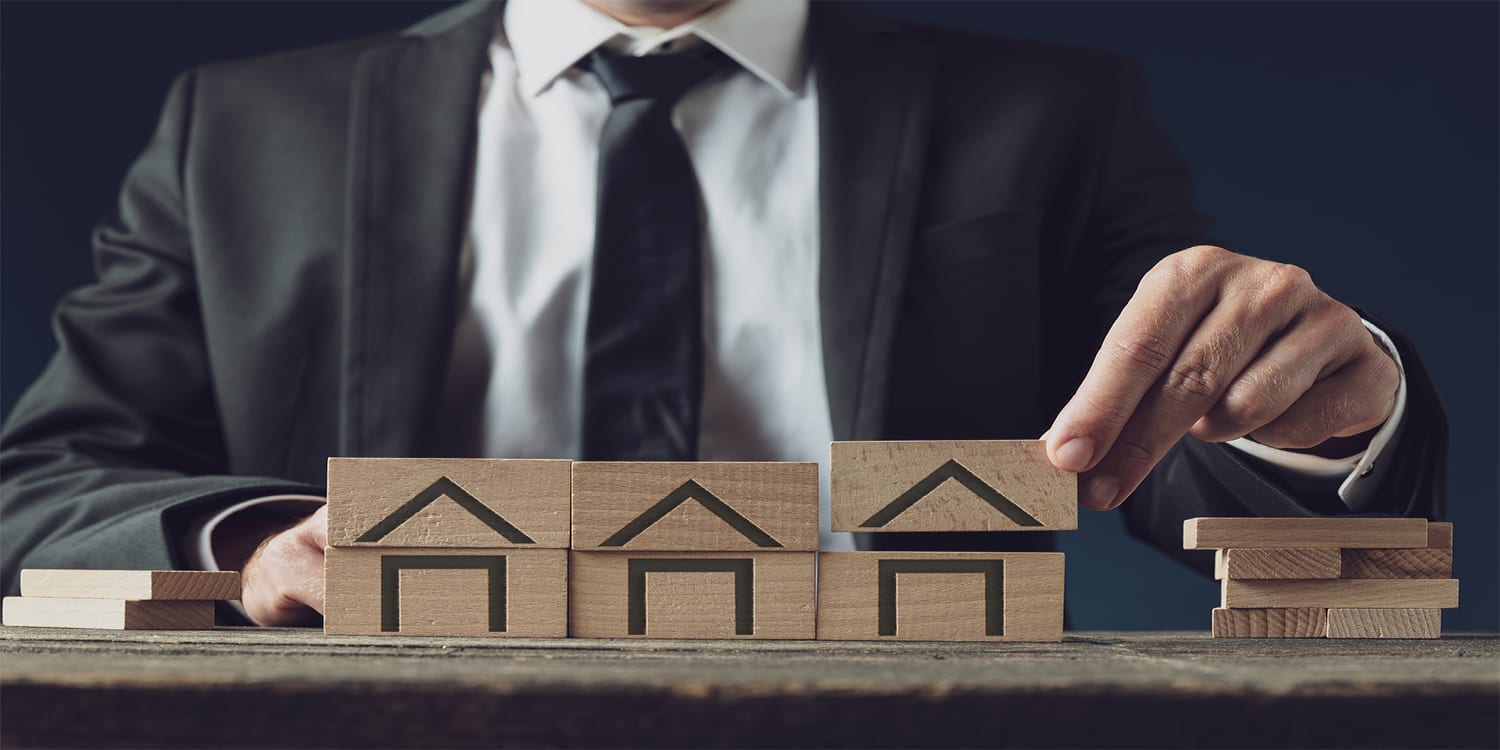 Real estate investment concept—fix and flip vs. buy and hold investing.